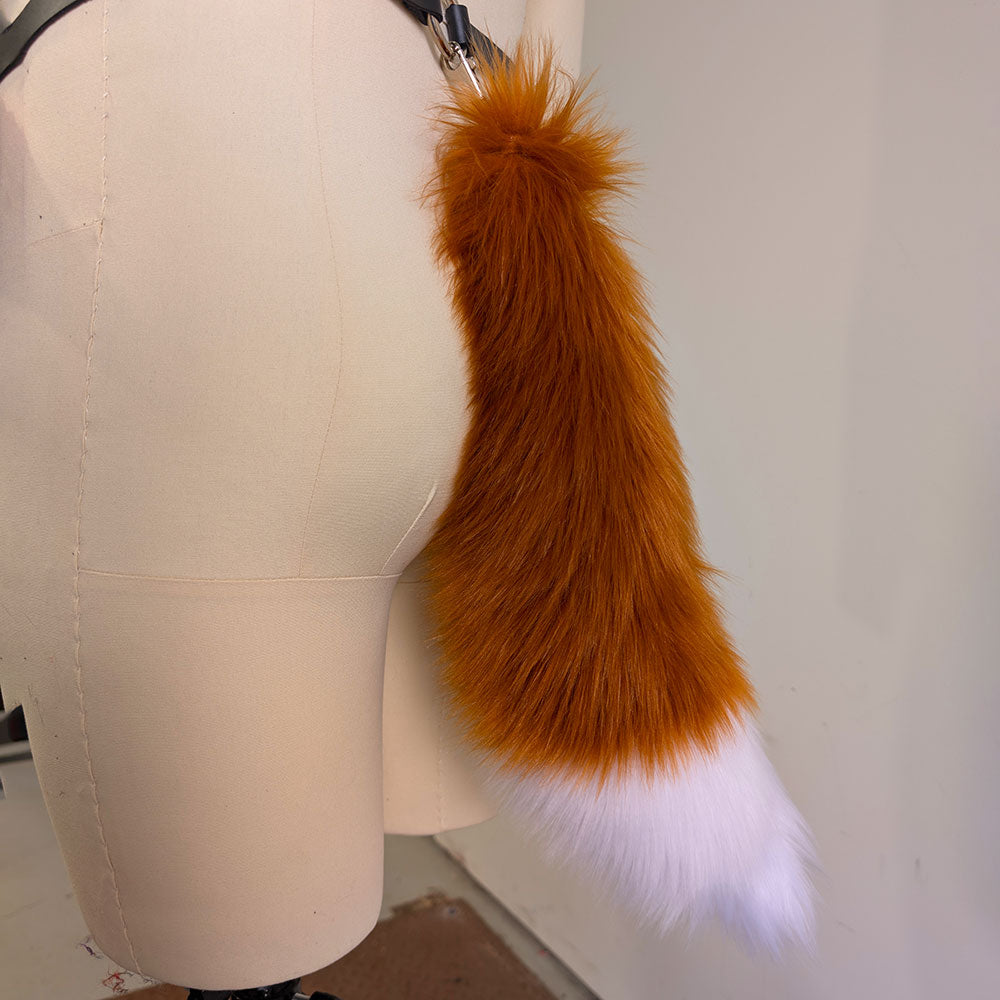Fur tail accessory on a mannequin with a plain background